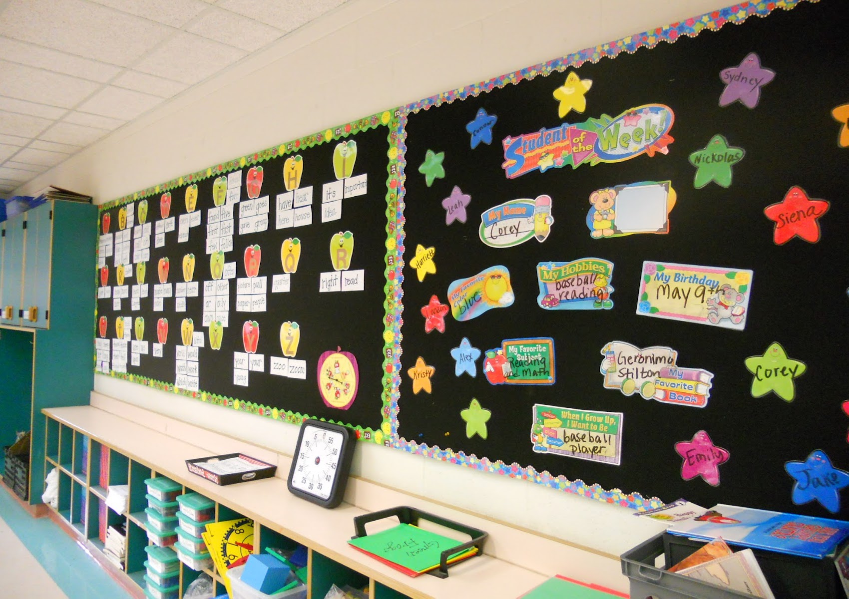 Classroom learning walls covered with black hook-receptive display fabric